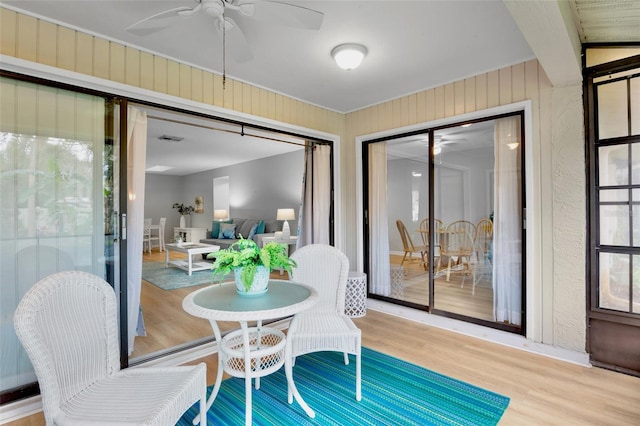 sunroom / solarium with visible vents and a ceiling fan