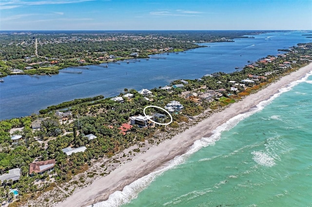 birds eye view of property featuring a beach view and a water view