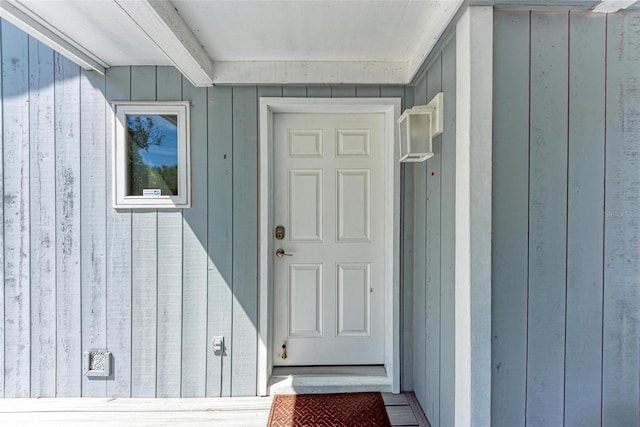 view of exterior entry with board and batten siding