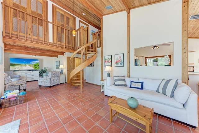 living area with visible vents, a towering ceiling, wood ceiling, stairway, and tile patterned floors