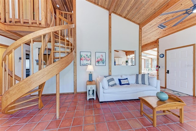 tiled living room featuring a ceiling fan, wood ceiling, high vaulted ceiling, and stairs