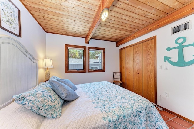 tiled bedroom featuring a closet, wooden ceiling, visible vents, and beam ceiling