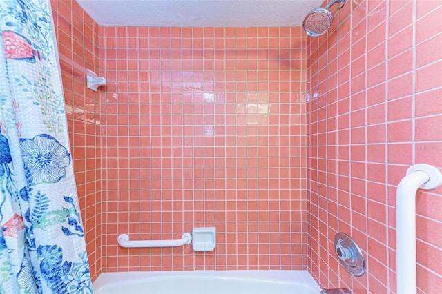 bathroom featuring a textured ceiling and shower / bath combo