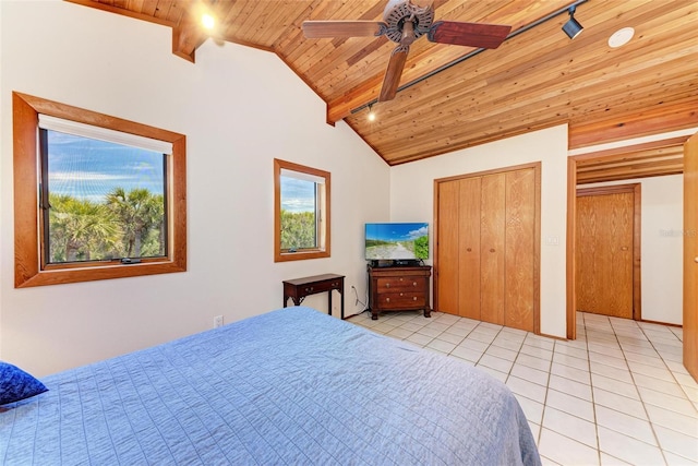 bedroom featuring lofted ceiling with beams, wooden ceiling, light tile patterned flooring, a ceiling fan, and rail lighting