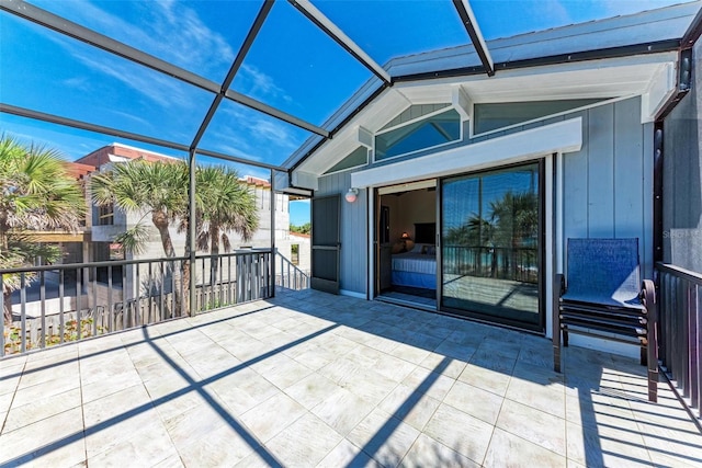 view of patio featuring glass enclosure