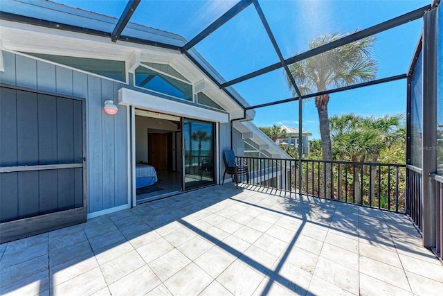 unfurnished sunroom featuring vaulted ceiling