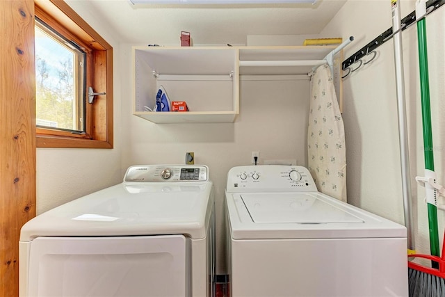 clothes washing area featuring laundry area and washer and dryer