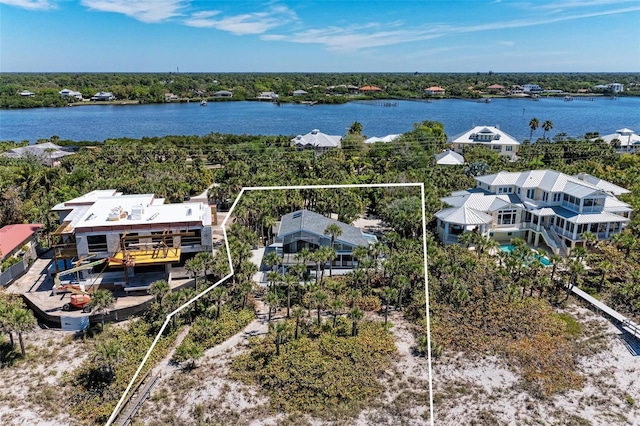 aerial view featuring a water view and a wooded view