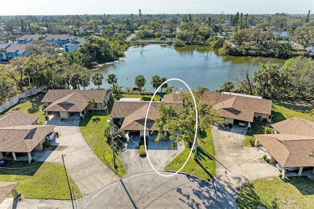 birds eye view of property with a water view and a residential view