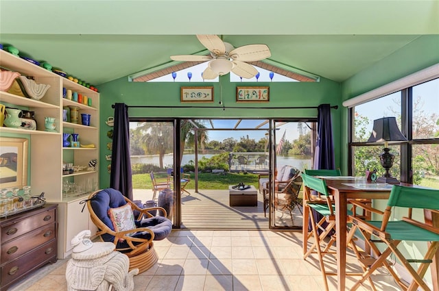 sunroom / solarium with a water view, ceiling fan, and lofted ceiling