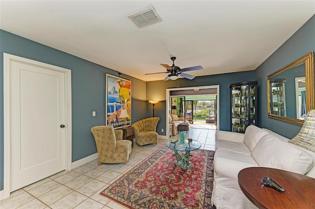 living room with light tile patterned floors, baseboards, visible vents, and a ceiling fan