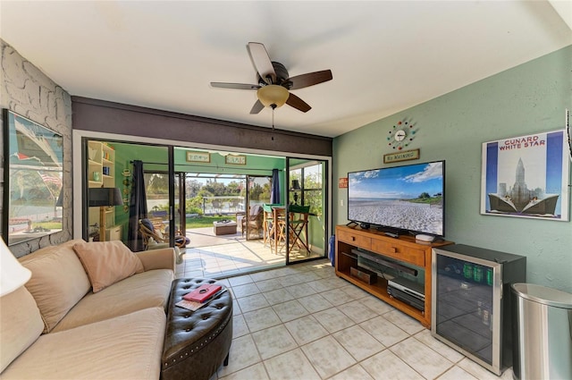 living area with light tile patterned floors, a sunroom, and a ceiling fan