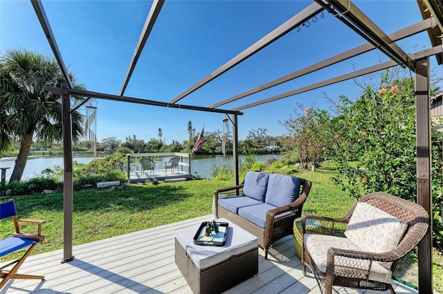 deck with a water view, a lawn, and outdoor lounge area