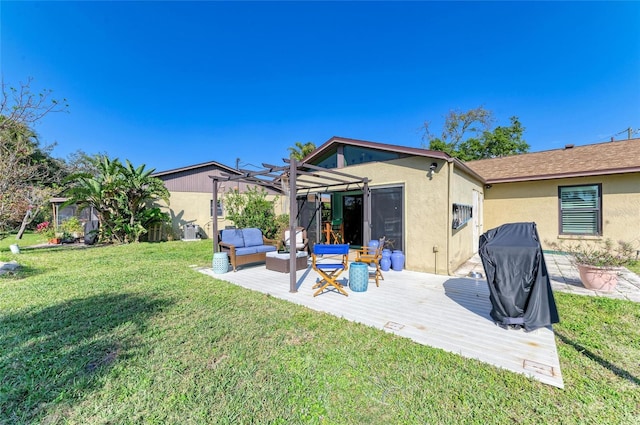 rear view of property with outdoor lounge area, a lawn, a wooden deck, a pergola, and stucco siding