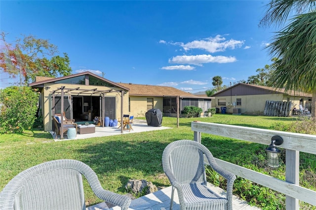 back of house with a yard, a patio, and outdoor lounge area