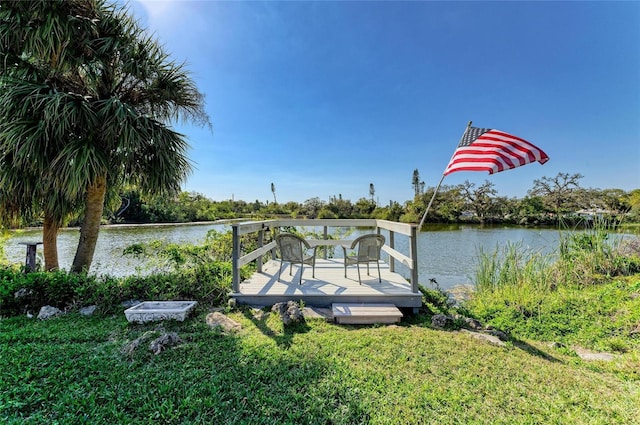 dock area featuring a lawn and a water view