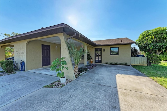 view of front of house with fence and stucco siding