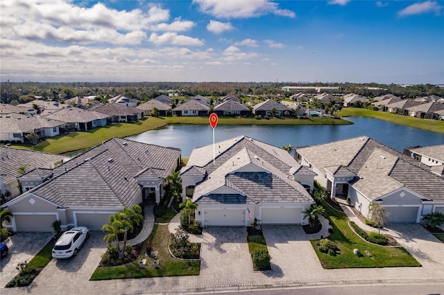 drone / aerial view featuring a residential view and a water view