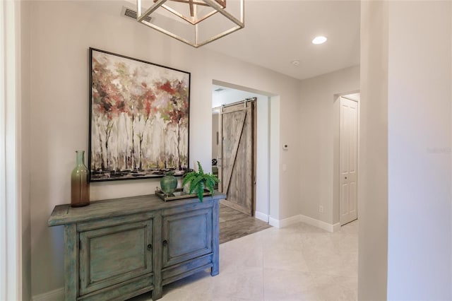 hall with recessed lighting, baseboards, and a barn door