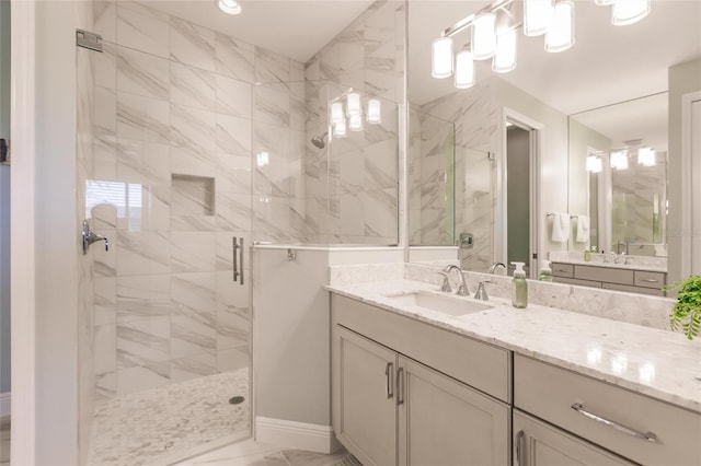 bathroom with marble finish floor, a stall shower, and vanity