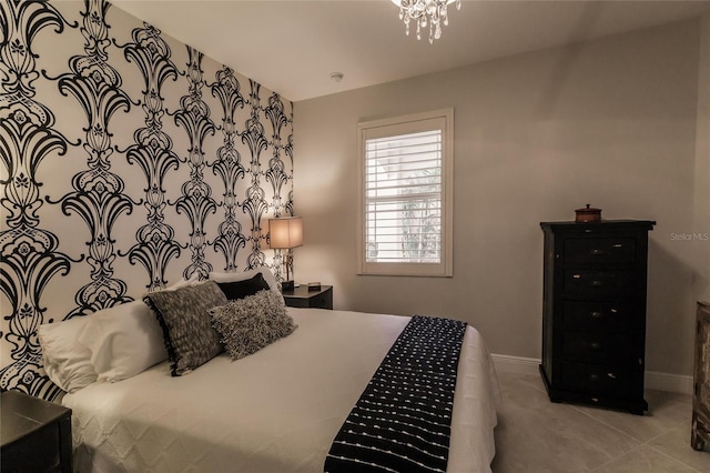 bedroom with a notable chandelier and baseboards