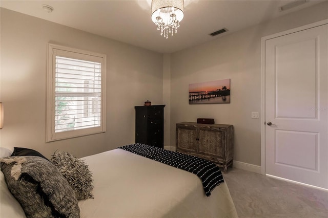 bedroom featuring baseboards, visible vents, and a notable chandelier