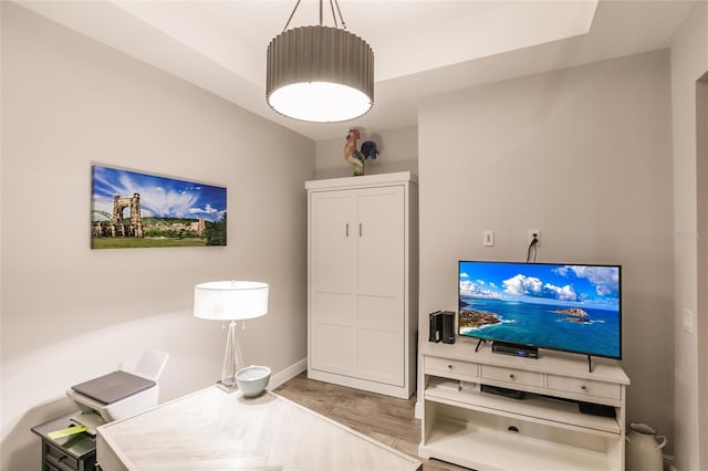 interior space featuring baseboards and wood finished floors