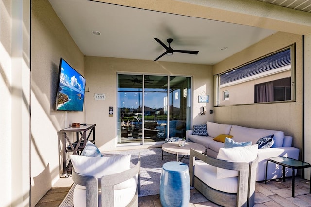 view of patio / terrace with ceiling fan and an outdoor living space