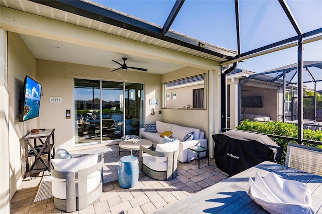 view of patio with an outdoor living space, a lanai, a ceiling fan, and a grill