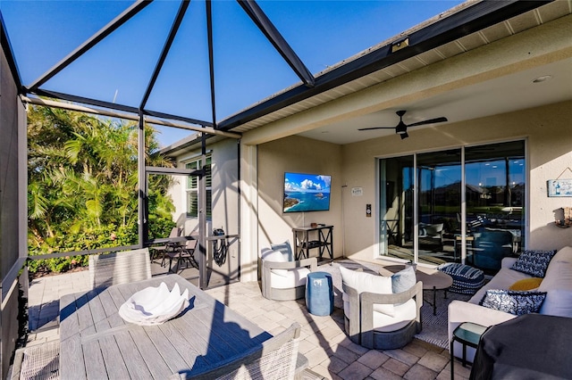 view of patio / terrace with glass enclosure, outdoor lounge area, and ceiling fan