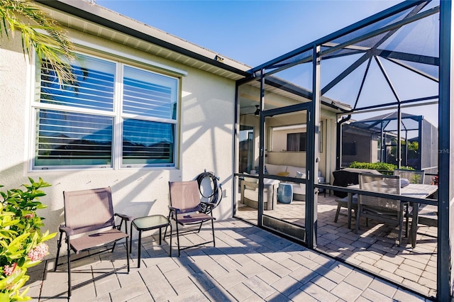 exterior space with outdoor dining space and glass enclosure