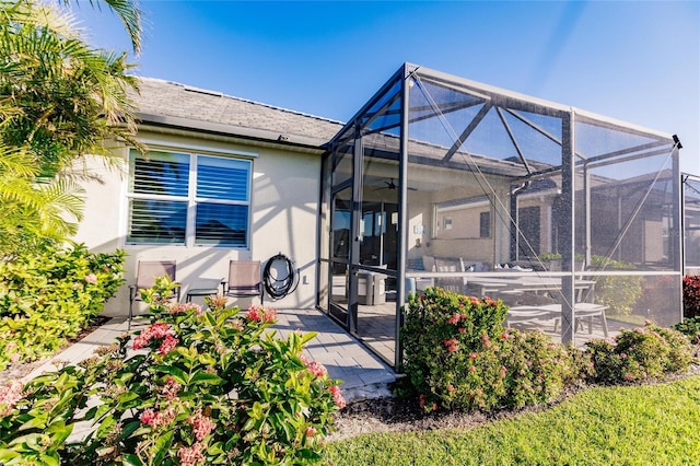 back of property featuring a patio, a lanai, and stucco siding