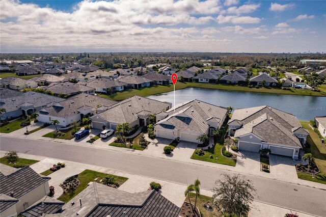 birds eye view of property featuring a water view and a residential view