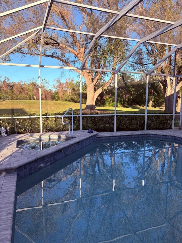 pool with glass enclosure and a patio area