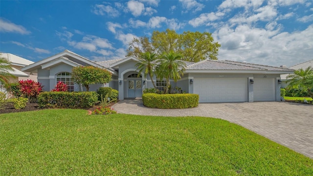 single story home featuring stucco siding, a front yard, decorative driveway, and a garage