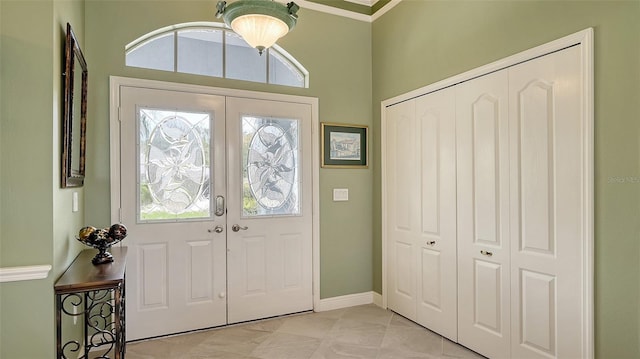 foyer entrance with french doors and baseboards