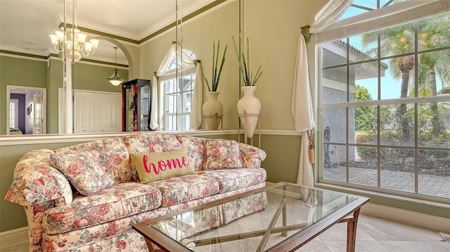 tiled living area with baseboards, an inviting chandelier, and ornamental molding