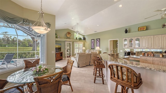 dining space featuring light tile patterned floors, visible vents, ceiling fan, and vaulted ceiling