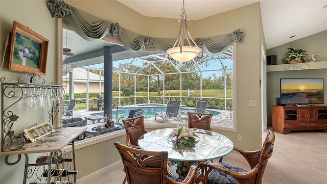 dining room featuring light tile patterned floors, lofted ceiling, and a sunroom