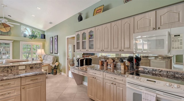 kitchen with visible vents, ceiling fan, vaulted ceiling, white appliances, and stone countertops