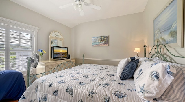 bedroom featuring baseboards, a ceiling fan, and vaulted ceiling