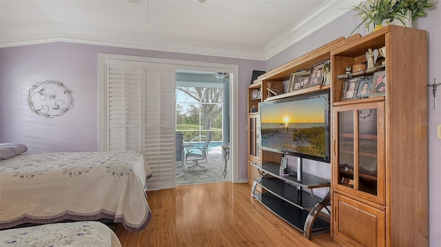 bedroom with light wood-style flooring, access to exterior, and crown molding