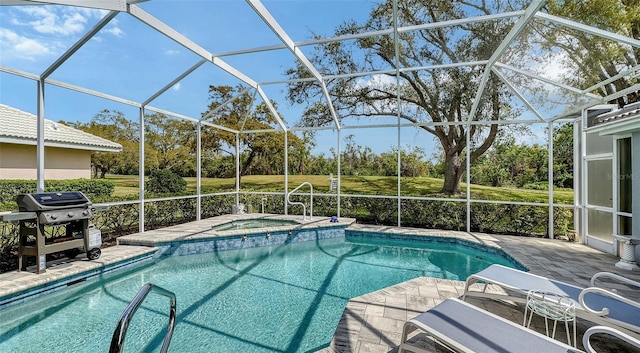 pool with glass enclosure, an in ground hot tub, and area for grilling