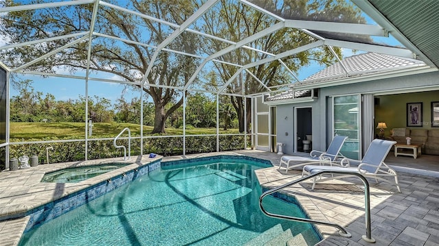 view of swimming pool with glass enclosure, a pool with connected hot tub, and a patio