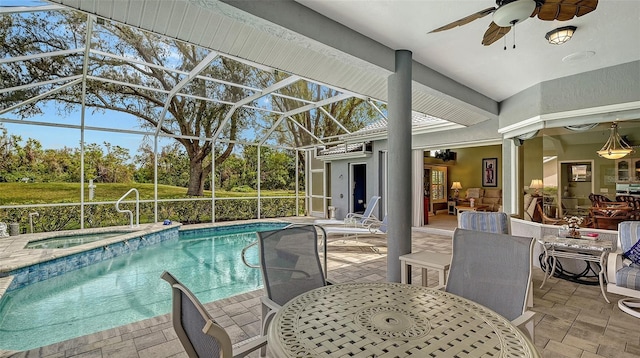 pool featuring glass enclosure, a patio, an in ground hot tub, outdoor dining area, and ceiling fan