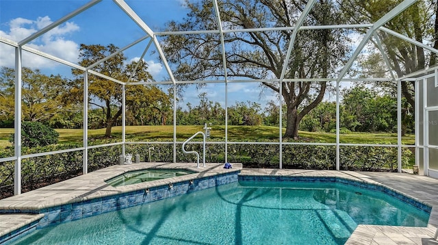 pool featuring glass enclosure, an in ground hot tub, and a lawn