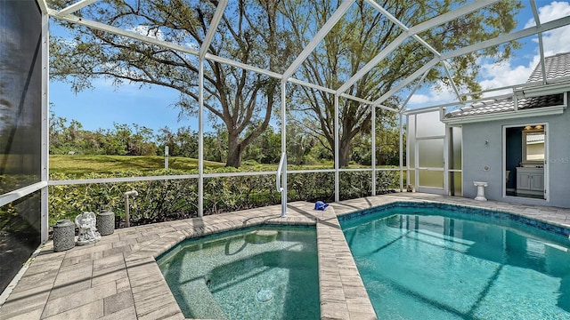 pool featuring glass enclosure and a patio