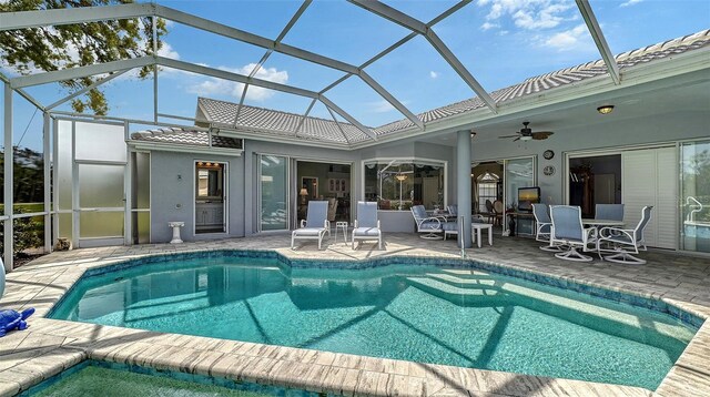 outdoor pool featuring a patio, a lanai, and a ceiling fan