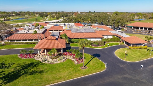 birds eye view of property with view of golf course, a water view, and a residential view