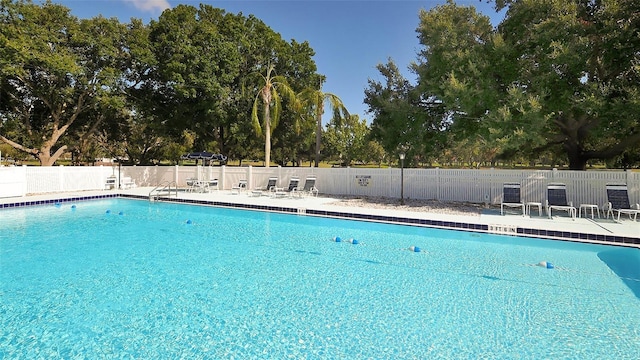 community pool featuring a patio area and fence